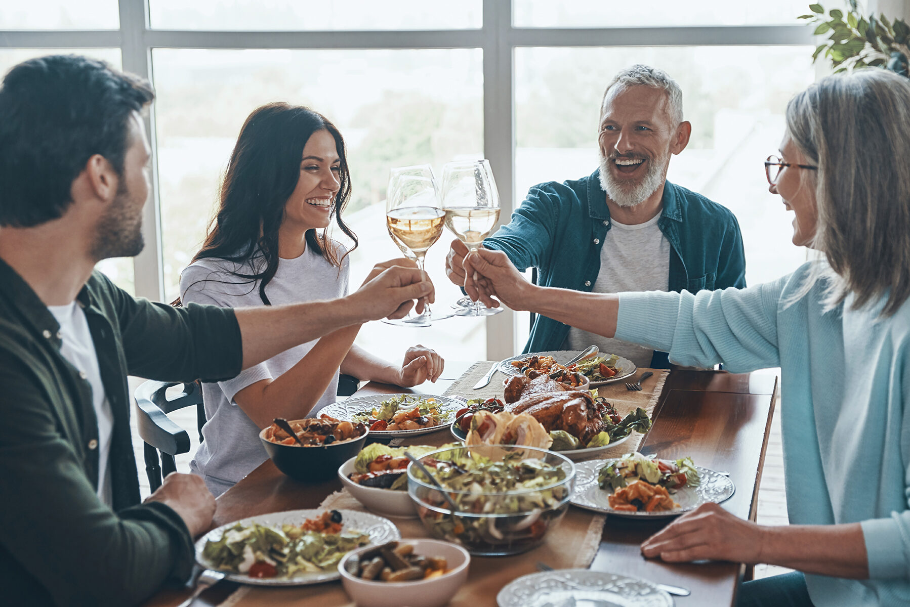 Happy,Multi-generation,Family,Toasting,Each,Other,And,Smiling,While,Having